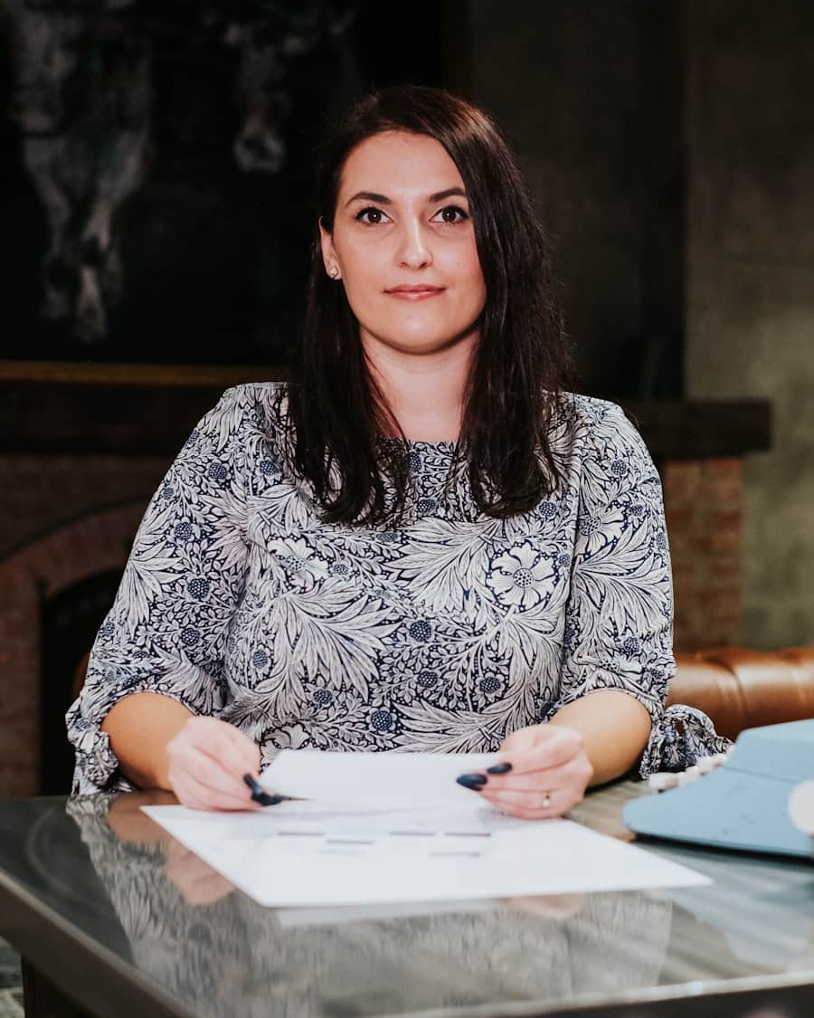 Joanna Bell, partner at Merritt & Bell, seated at her desk with papers in the firm's Franklin Street office
